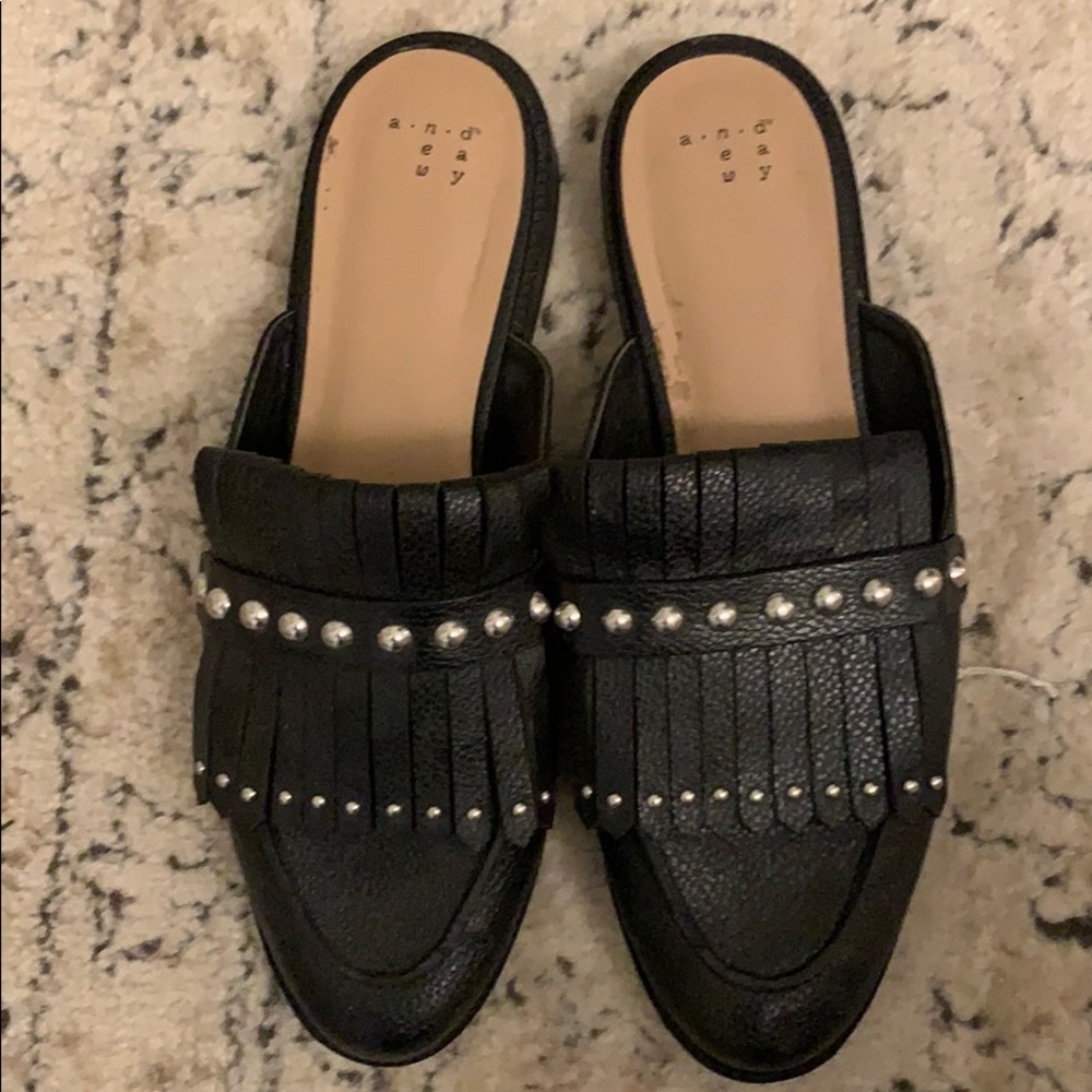 Black studded slip-ons with fringe!